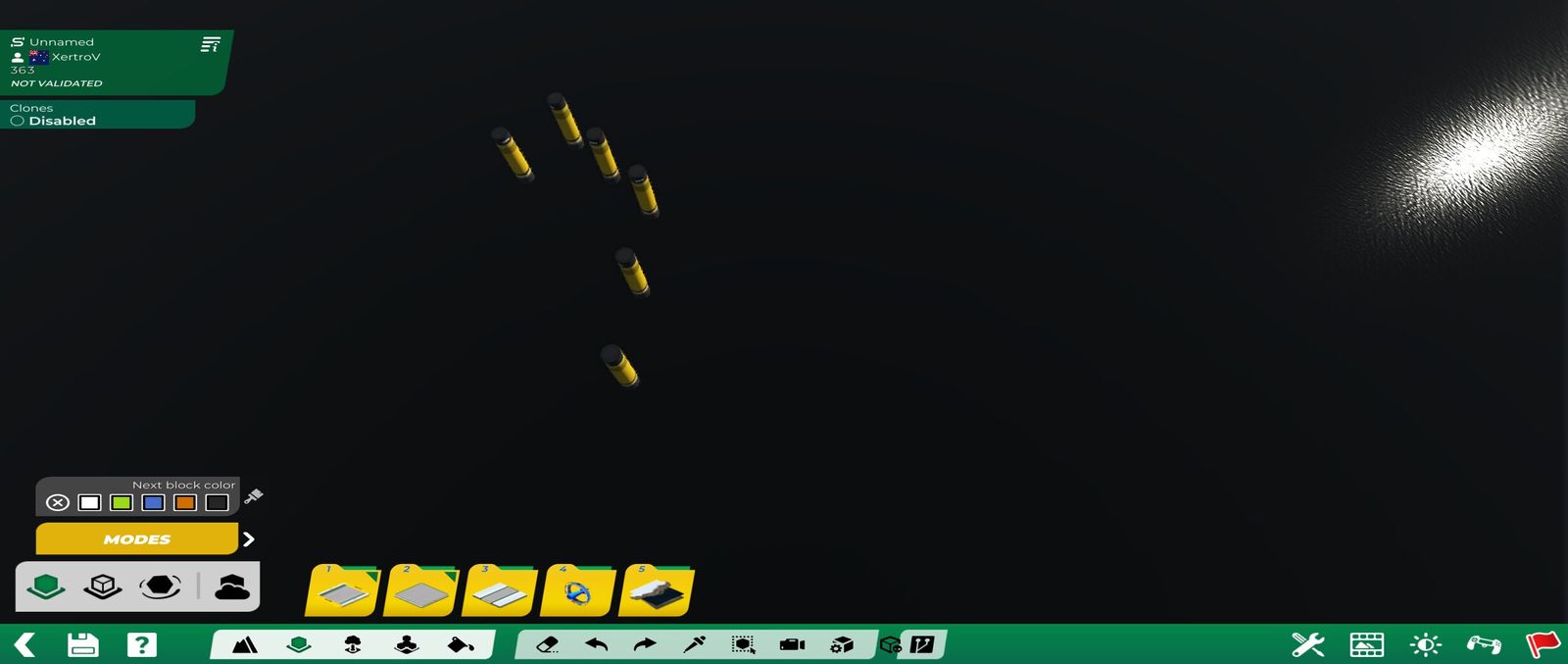 Trackmania map editor viewport: yellow pillar items placed on a dark ground, with the editor's green toolbar along the bottom and the yellow Modes button and block folders on the left.